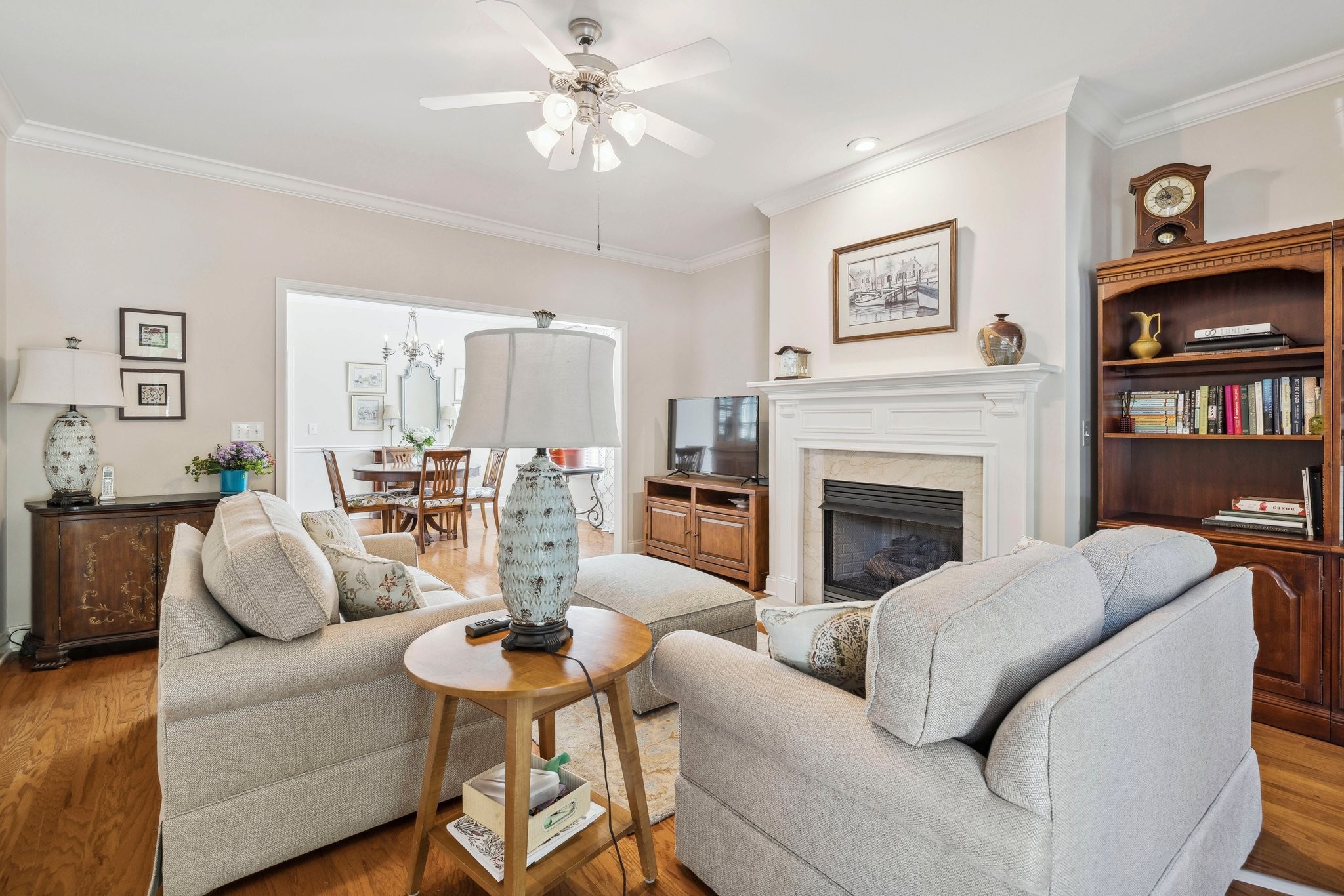 Witness quality craftsmanship in the exquisite hardwood flooring, fireplace mantle, and crown molding present in the living room.