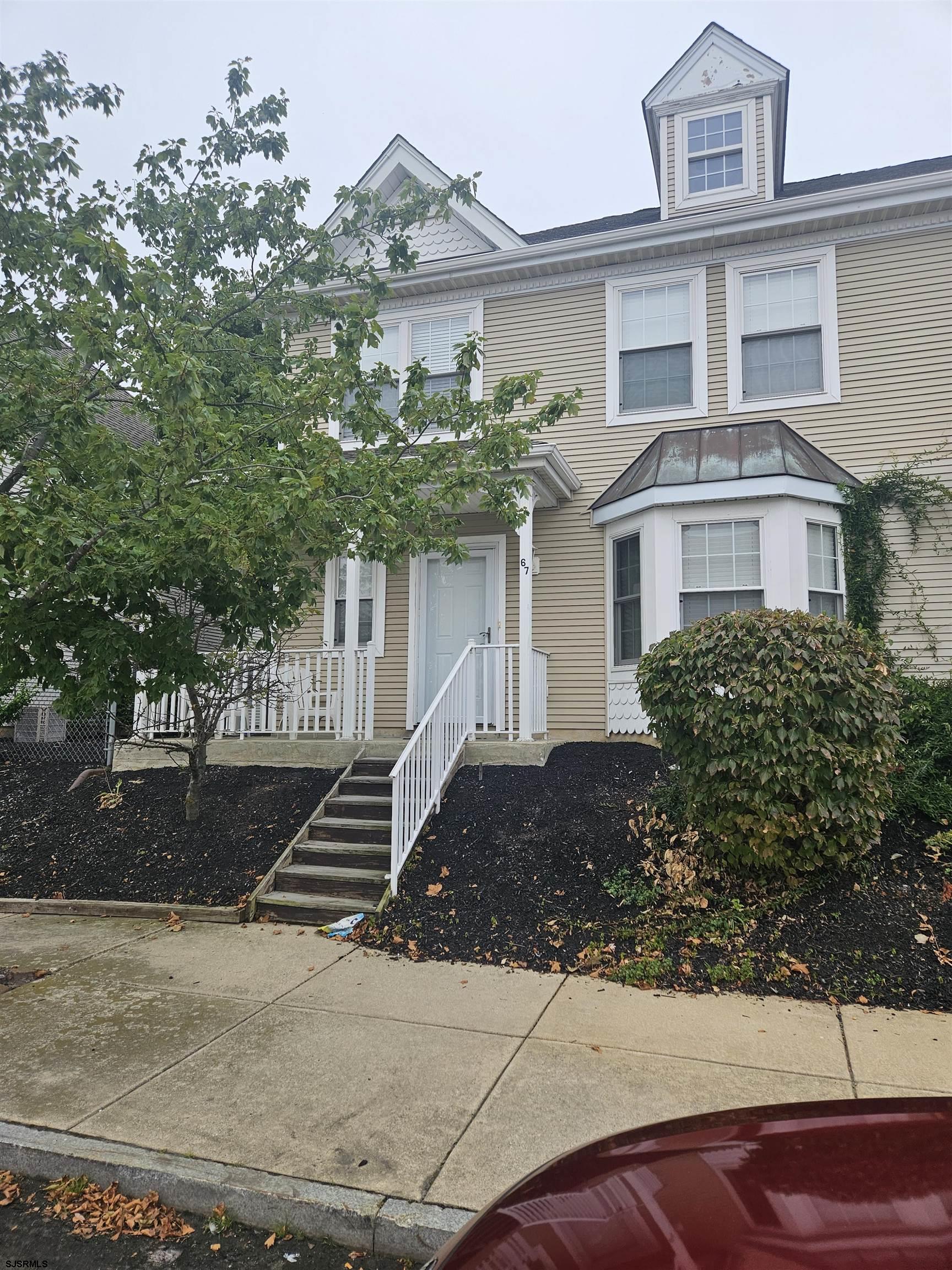 a front view of a house with a yard