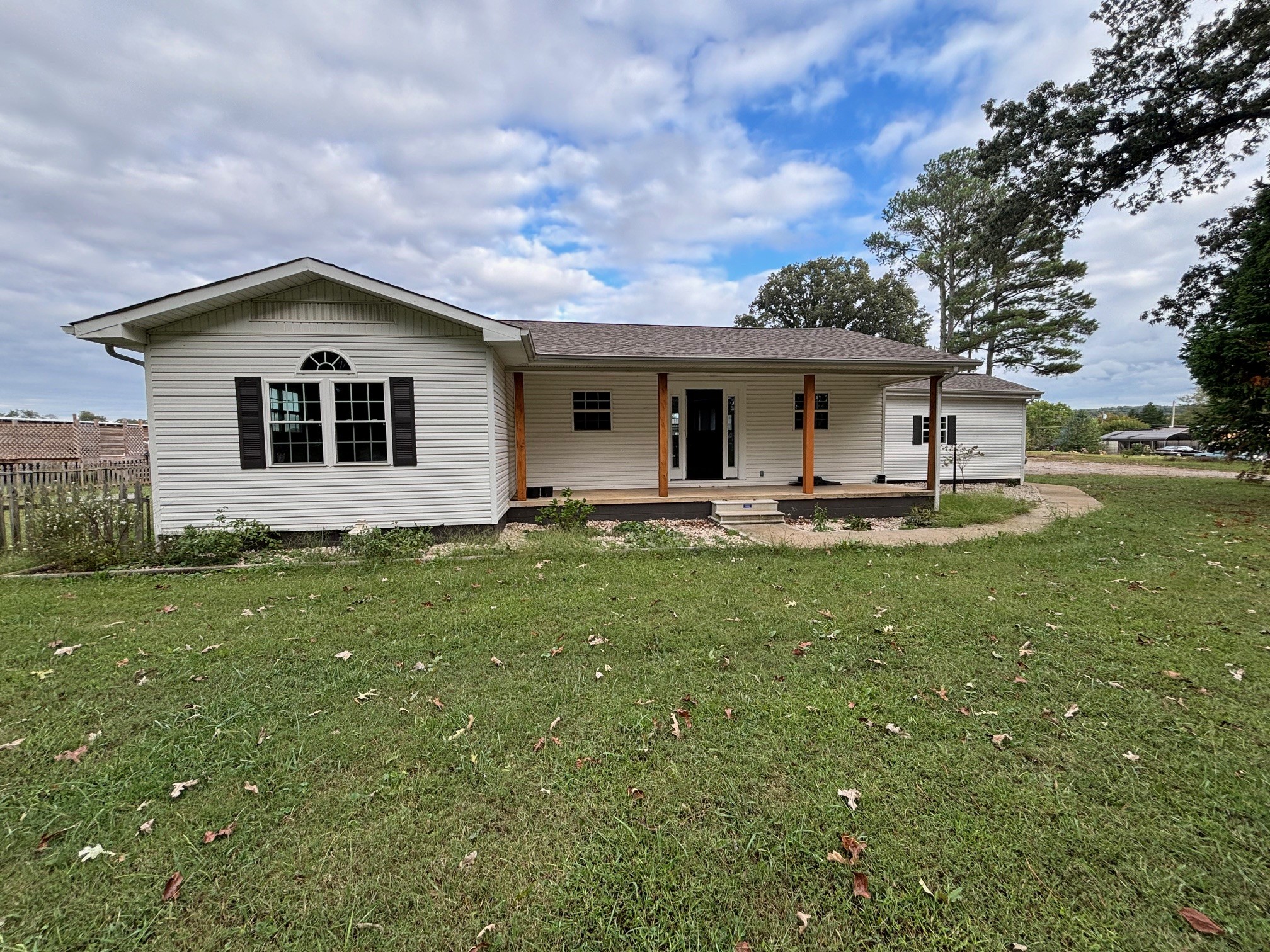 a front view of house with yard and green space