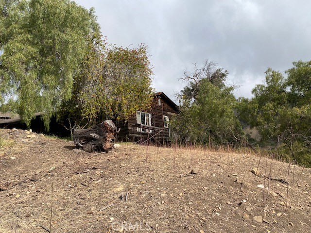 a view of house with a yard