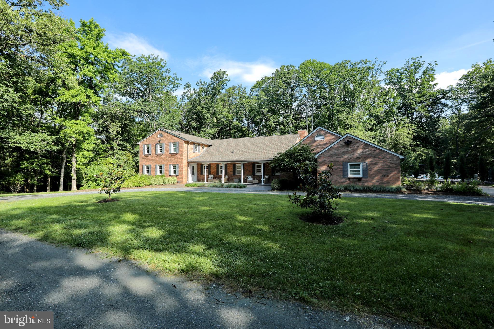 a aerial view of a house next to a big yard and large trees