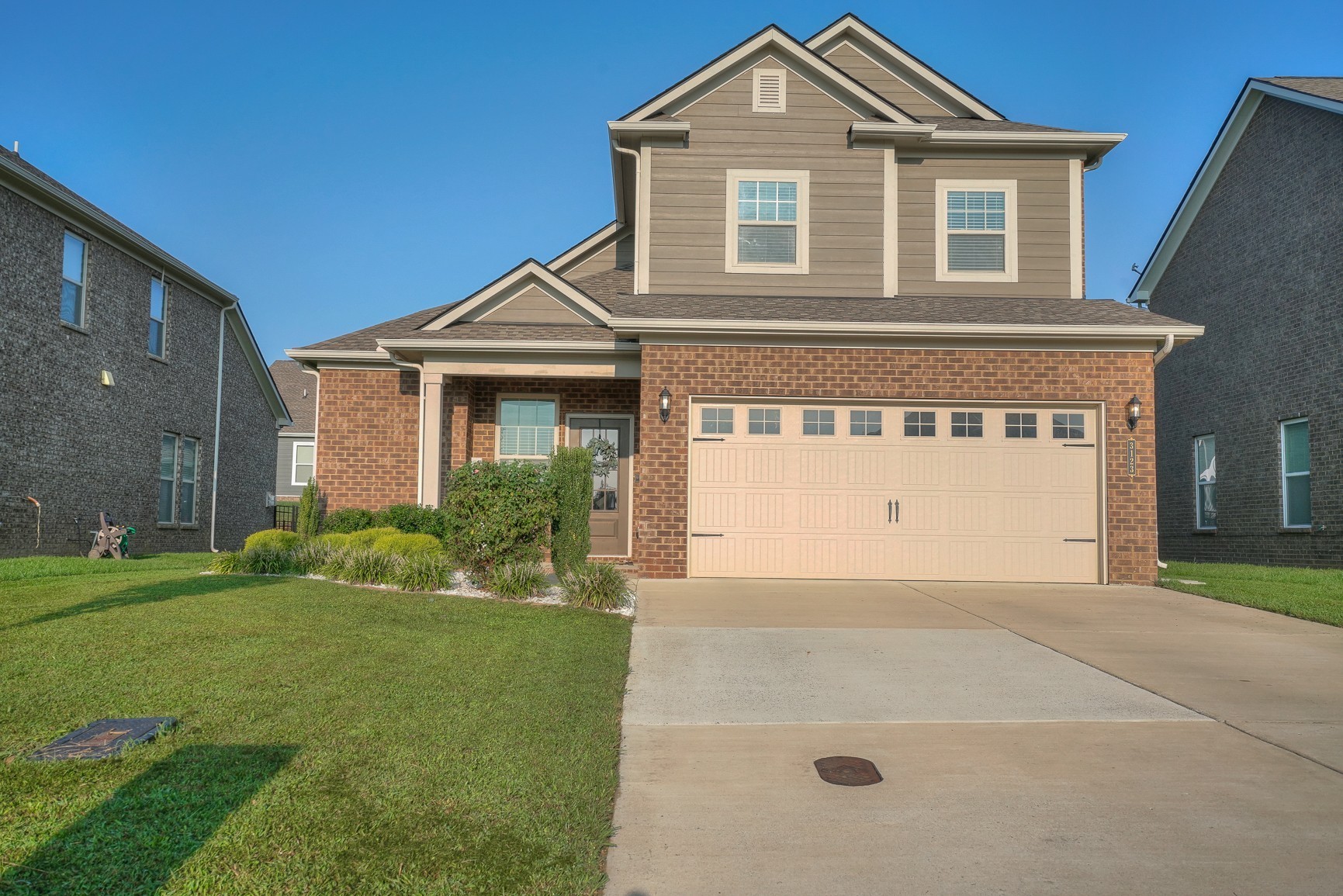 a front view of a house with a yard and garage