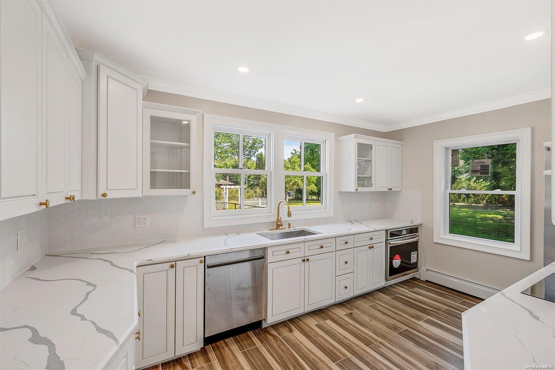 a kitchen that has a sink and a stove in it