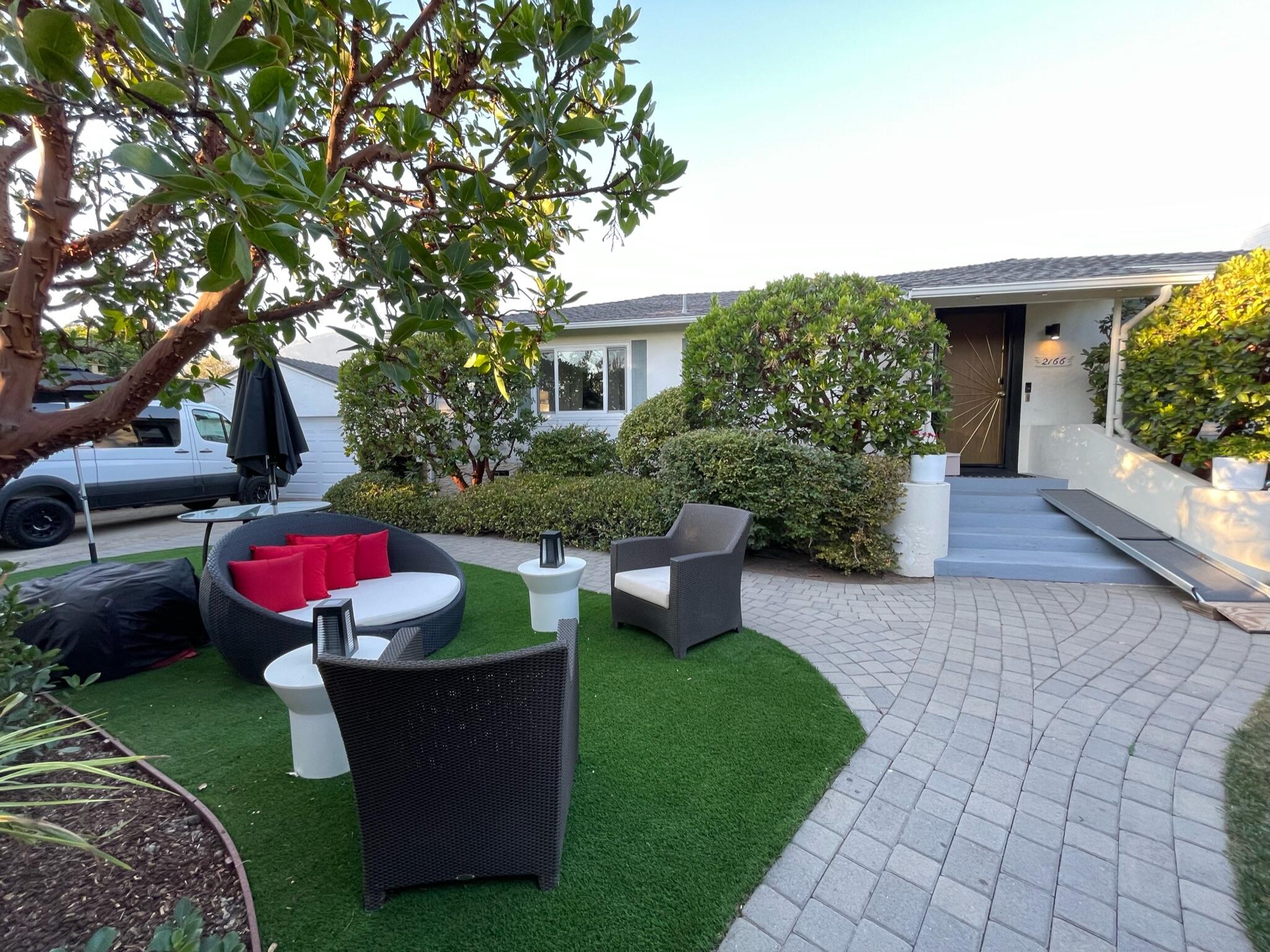 a view of a house with backyard sitting area and garden