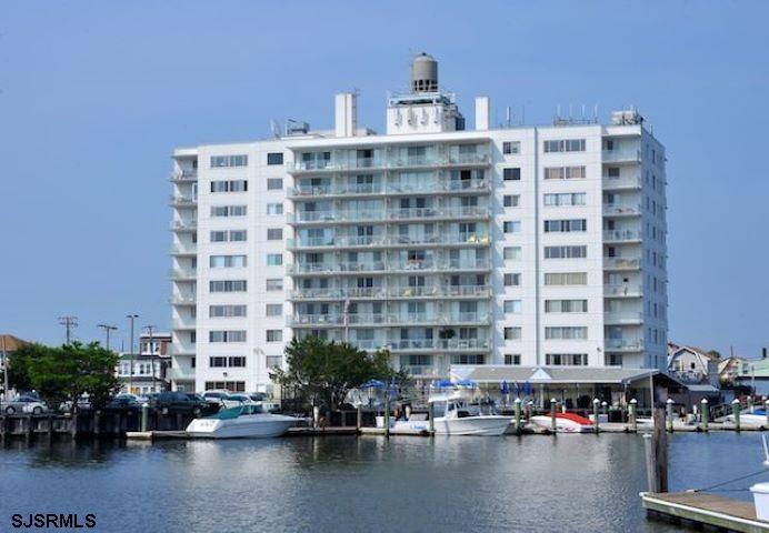 a tall building sitting on the middle of a lake