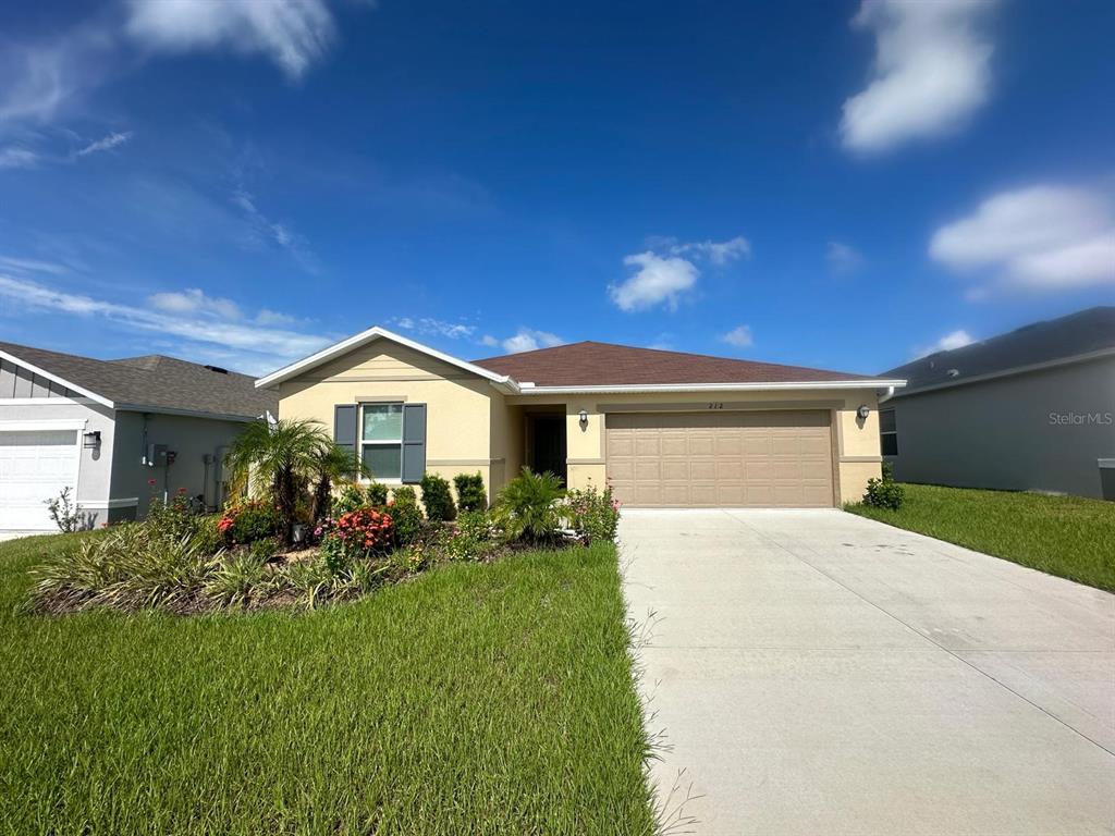 a front view of a house with a yard