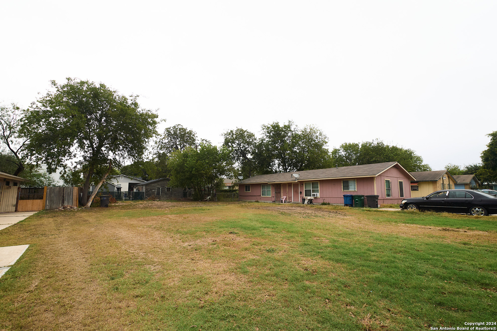 a view of a house with pool and a yard