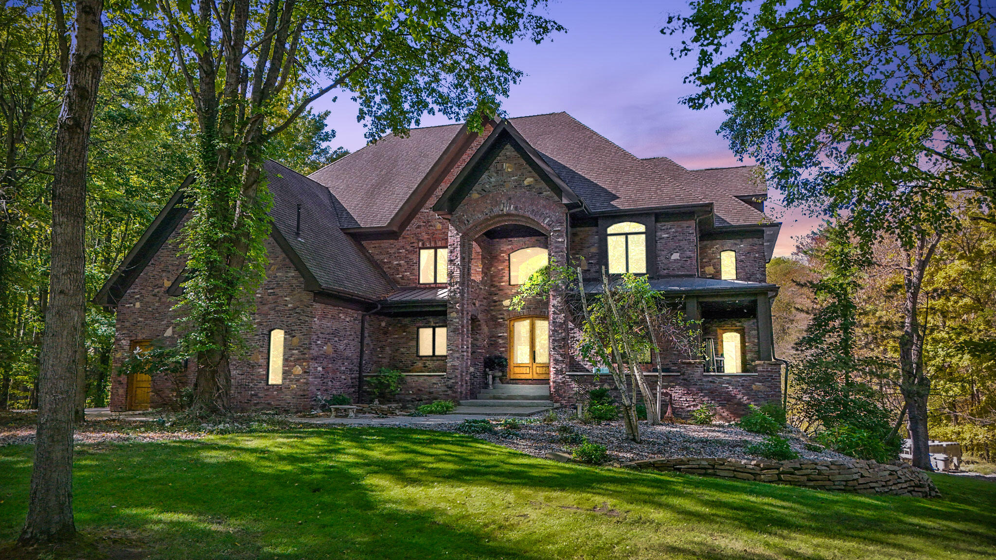 a front view of a house with a garden