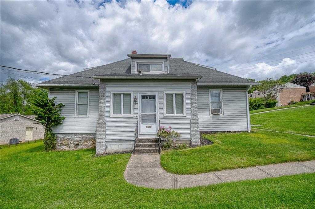 a front view of a house with a yard