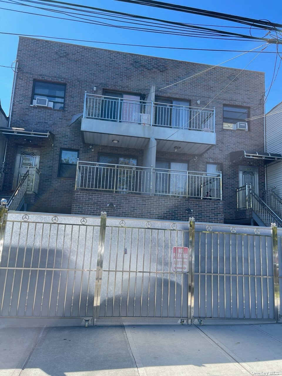 a view of a brick house with a small yard