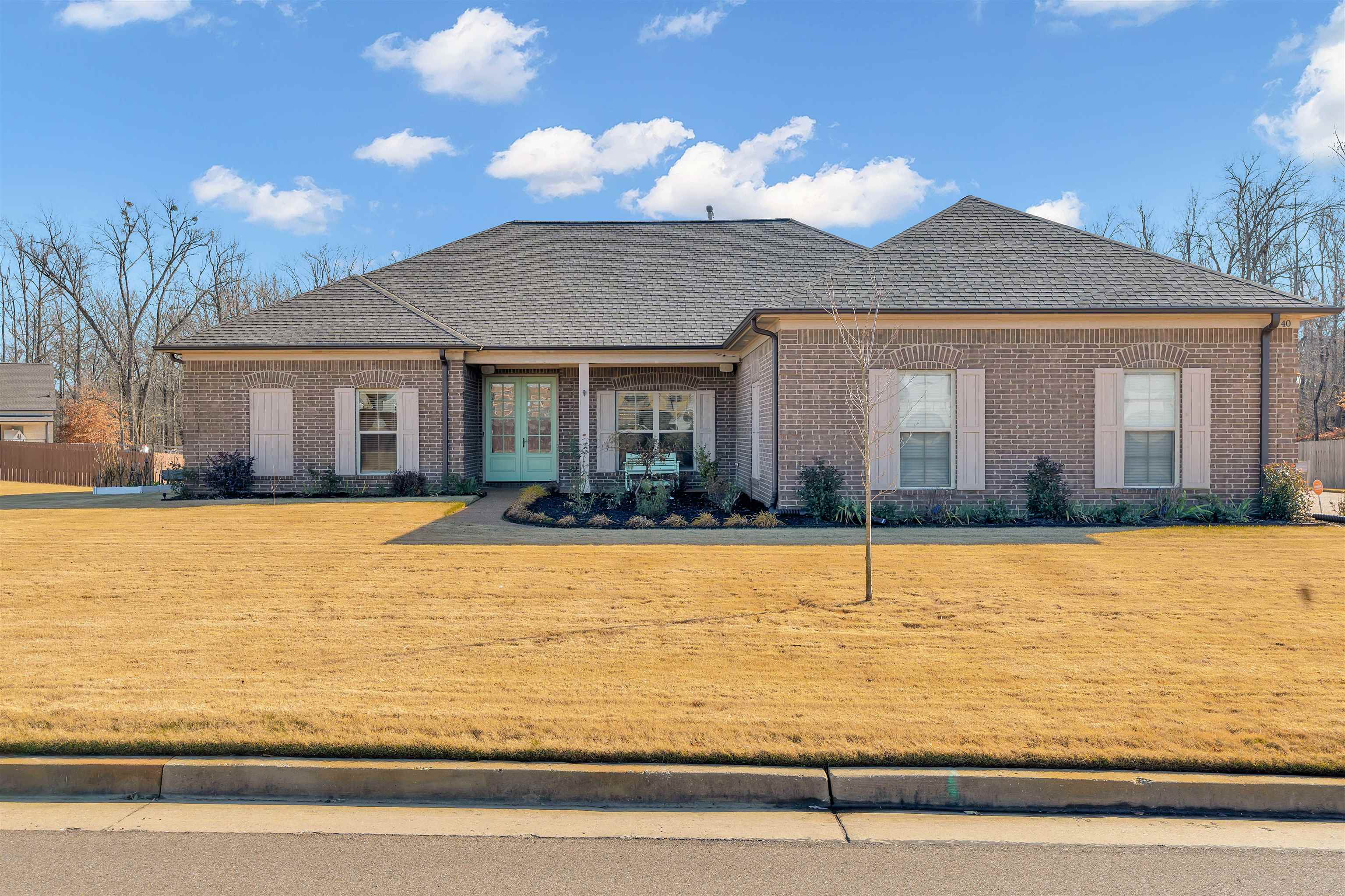 View of front facade featuring a front yard and french doors