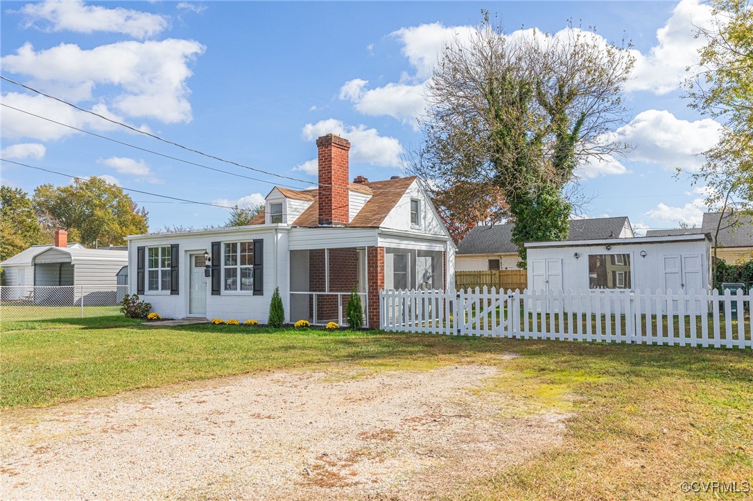 a front view of a house with a garden and yard