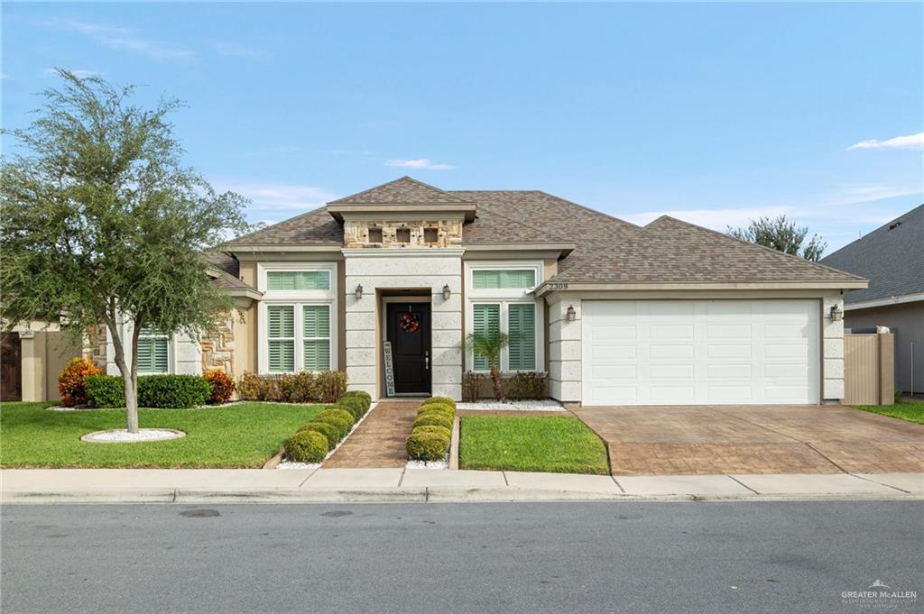 a front view of a house with a yard and garage