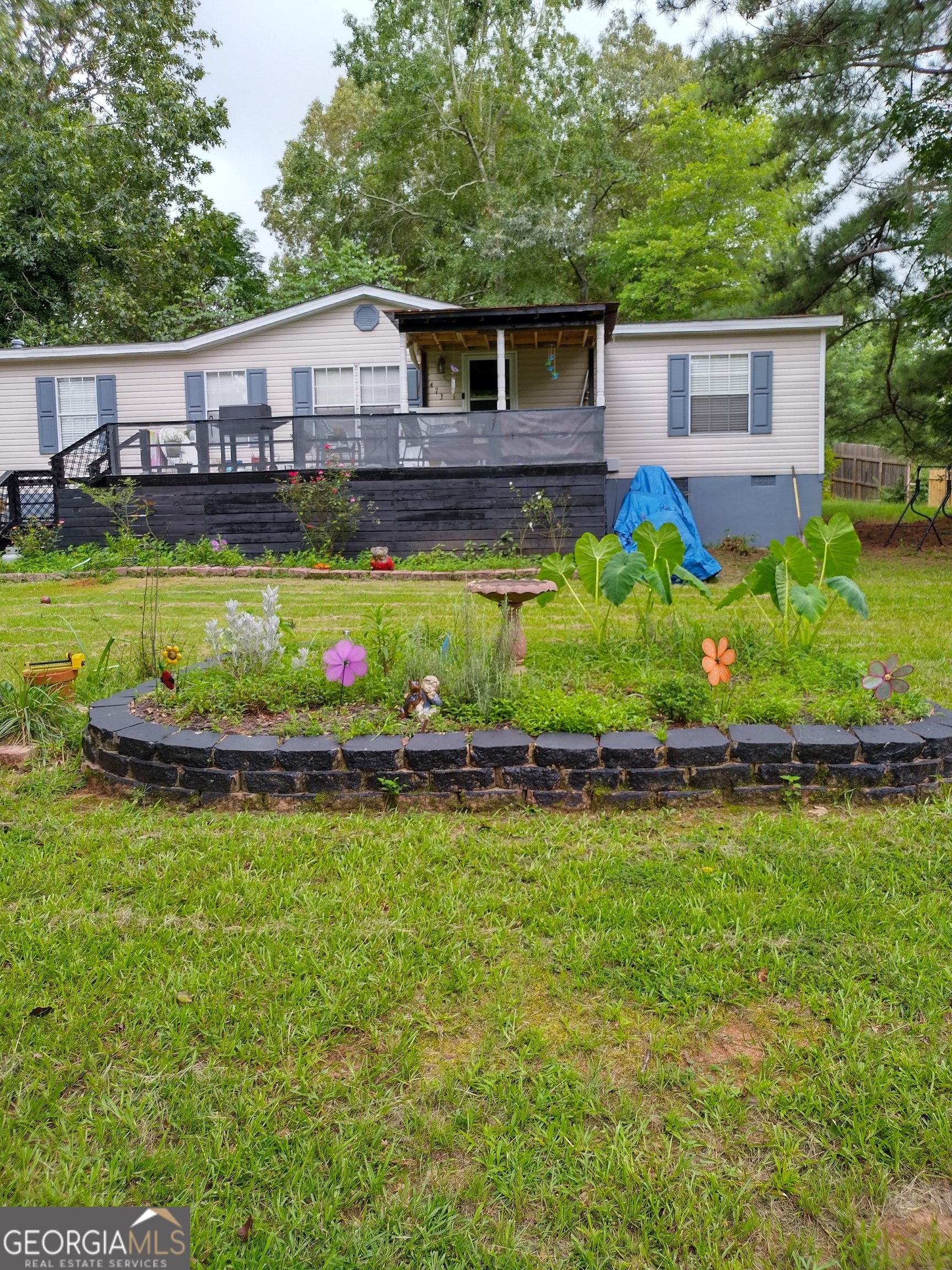 a view of a house with a yard and swimming pool