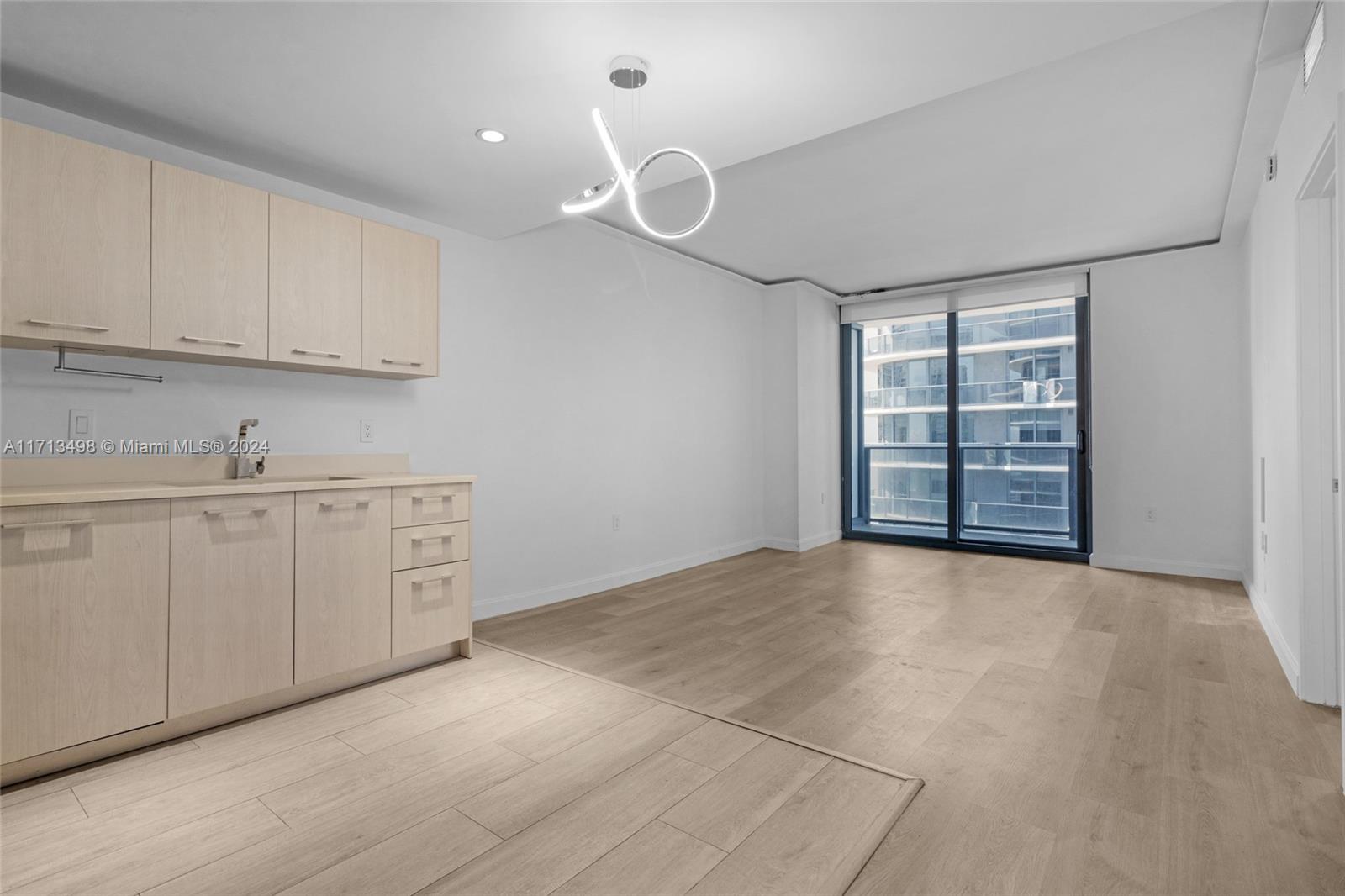 a view of a kitchen with cabinets