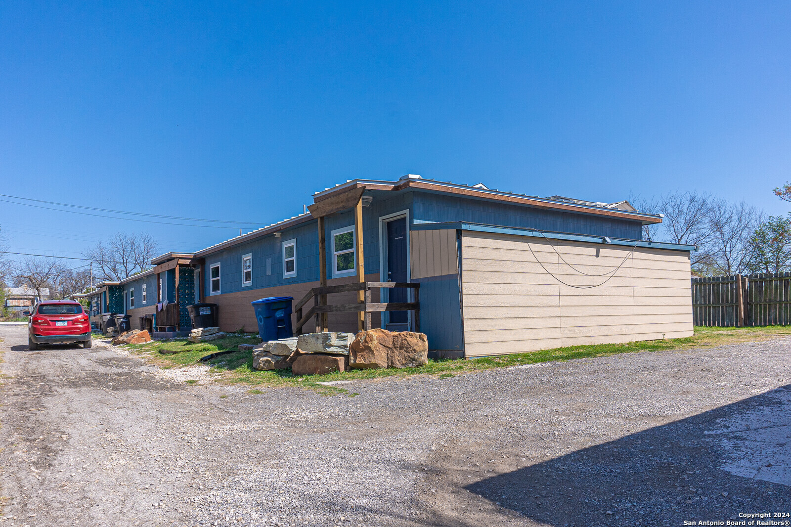 a view of a house with a yard and sitting area