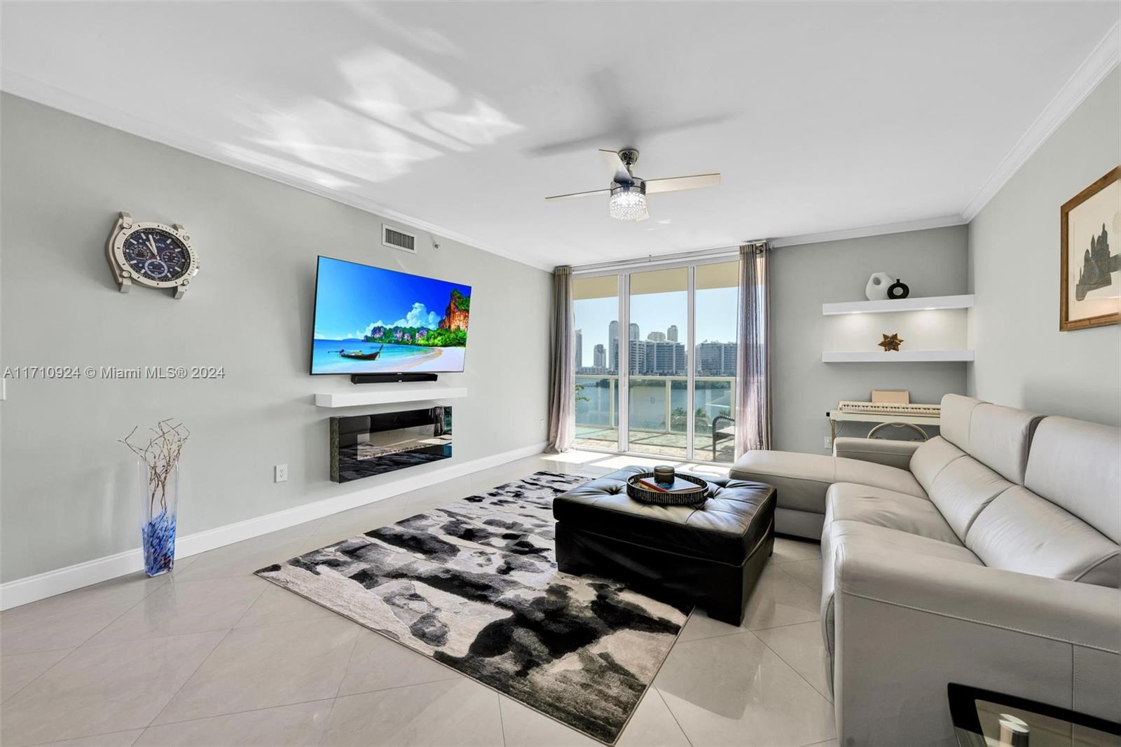 a living room with furniture a flat screen tv and a fireplace