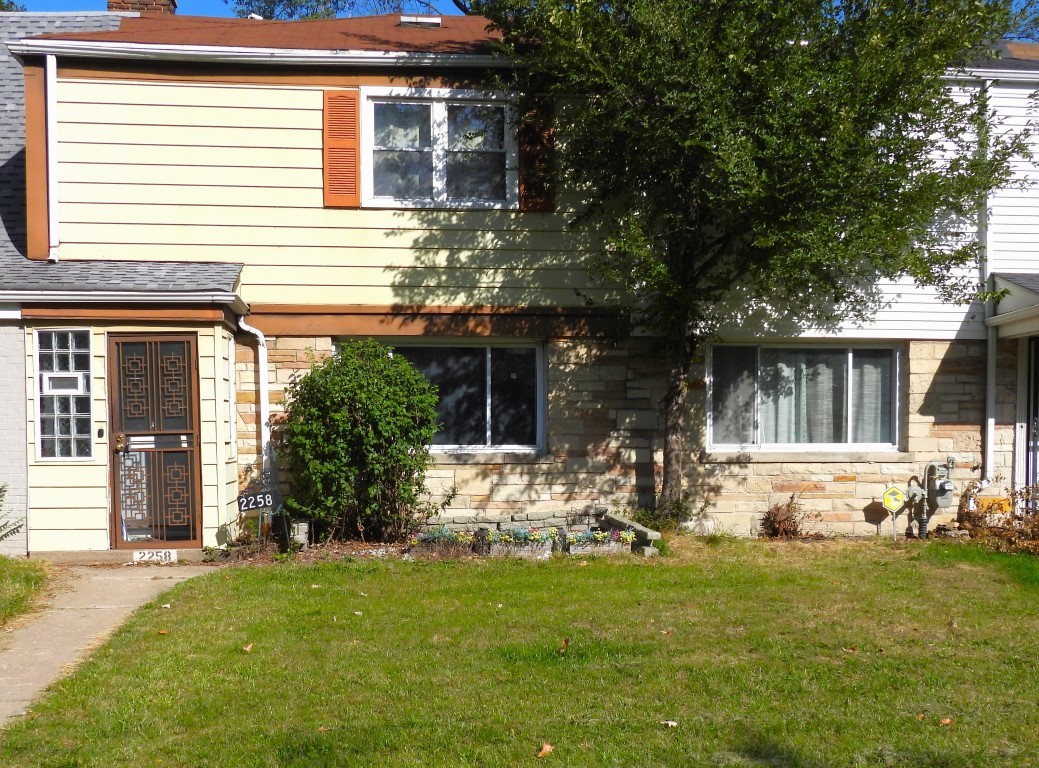 a front view of house with outdoor seating and yard