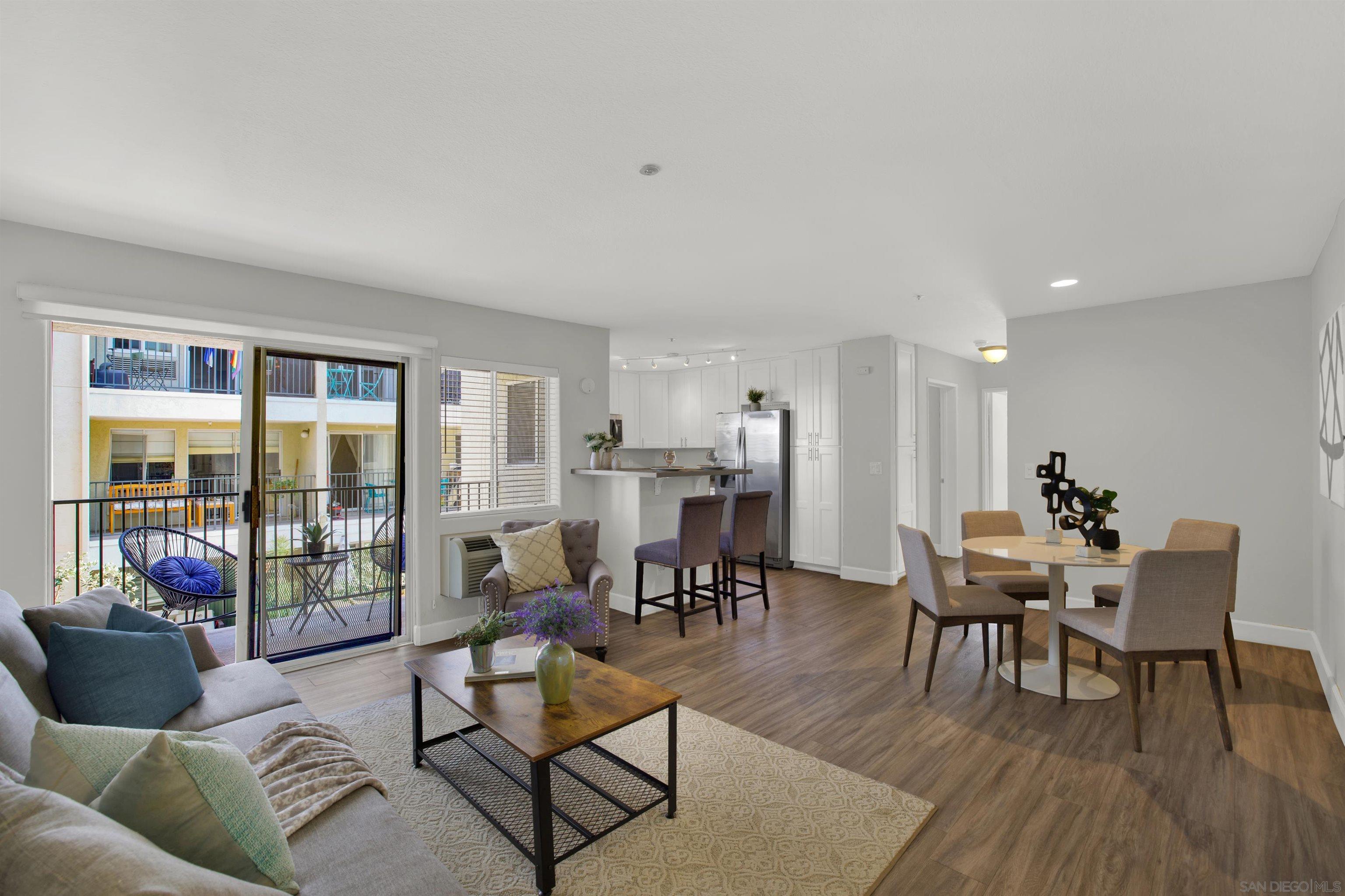 a living room with furniture and a floor to ceiling window