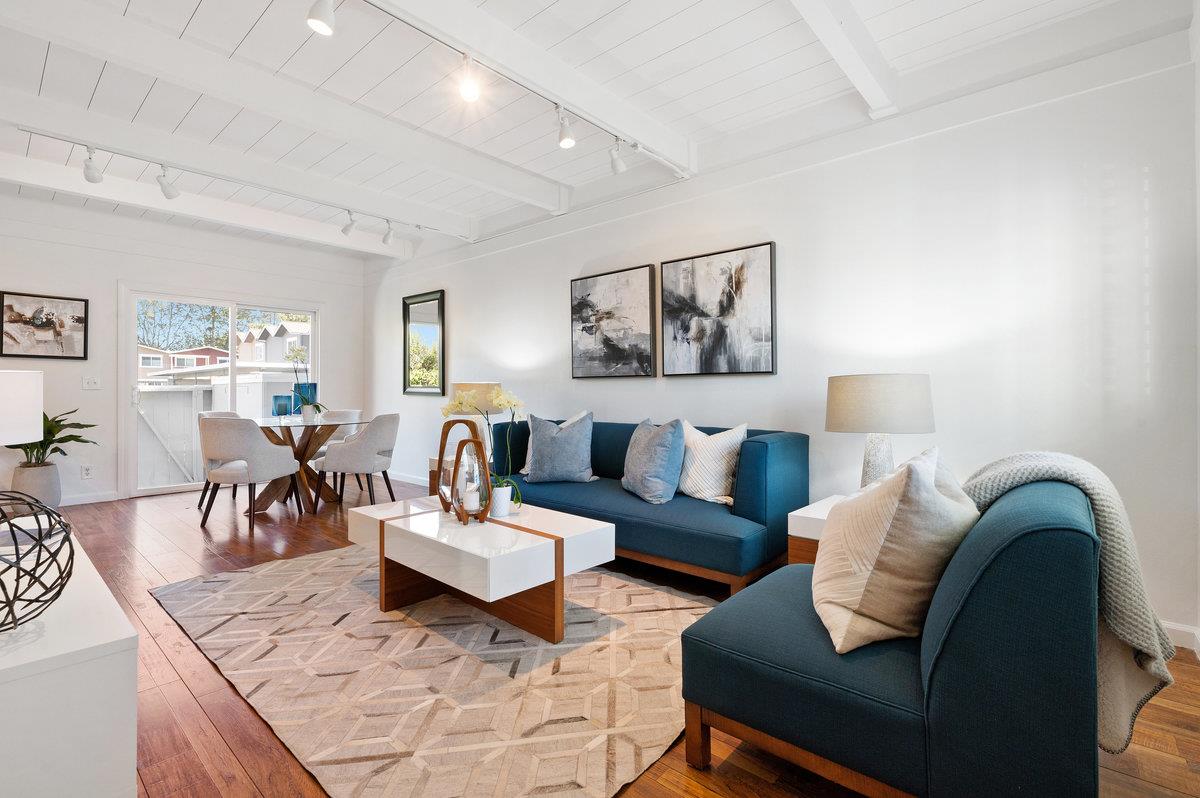 a living room with furniture and wooden floor