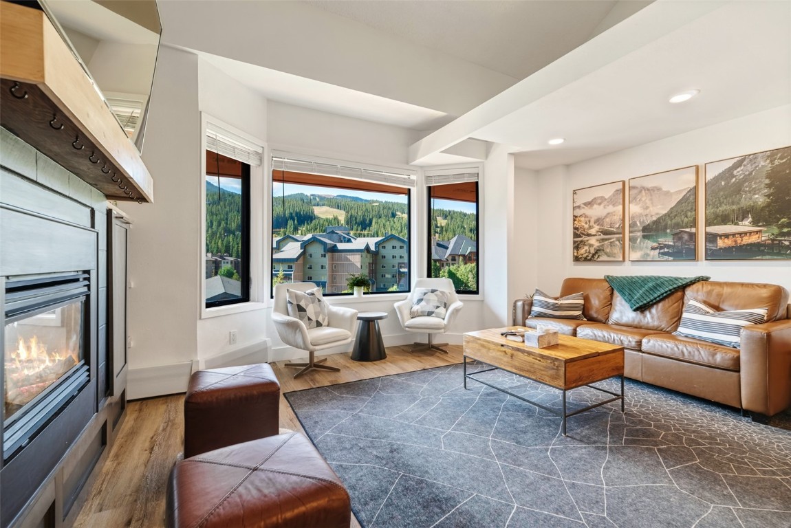 Living room with dark wood-type flooring