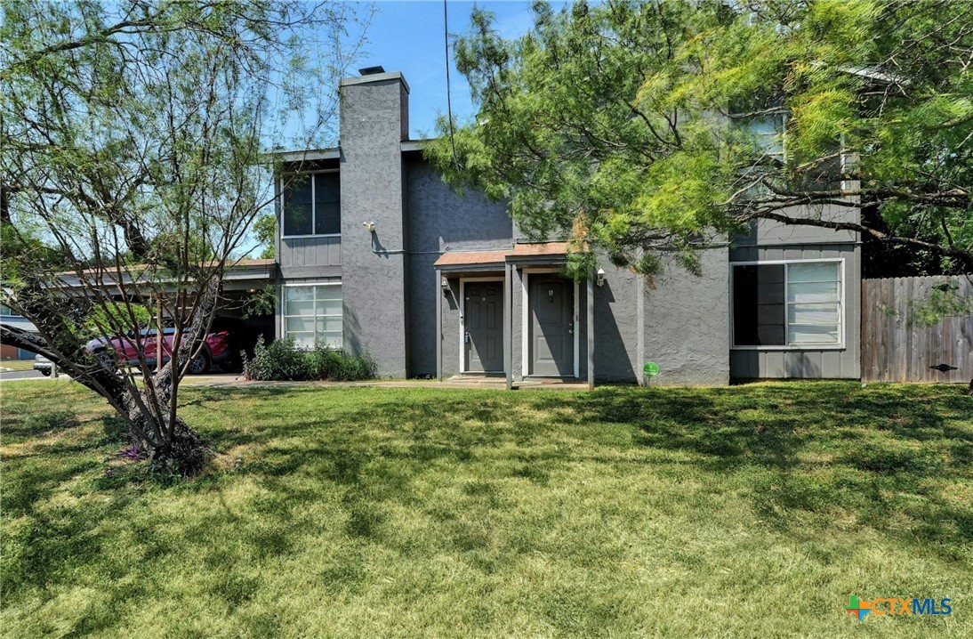 front view of a house with a tree