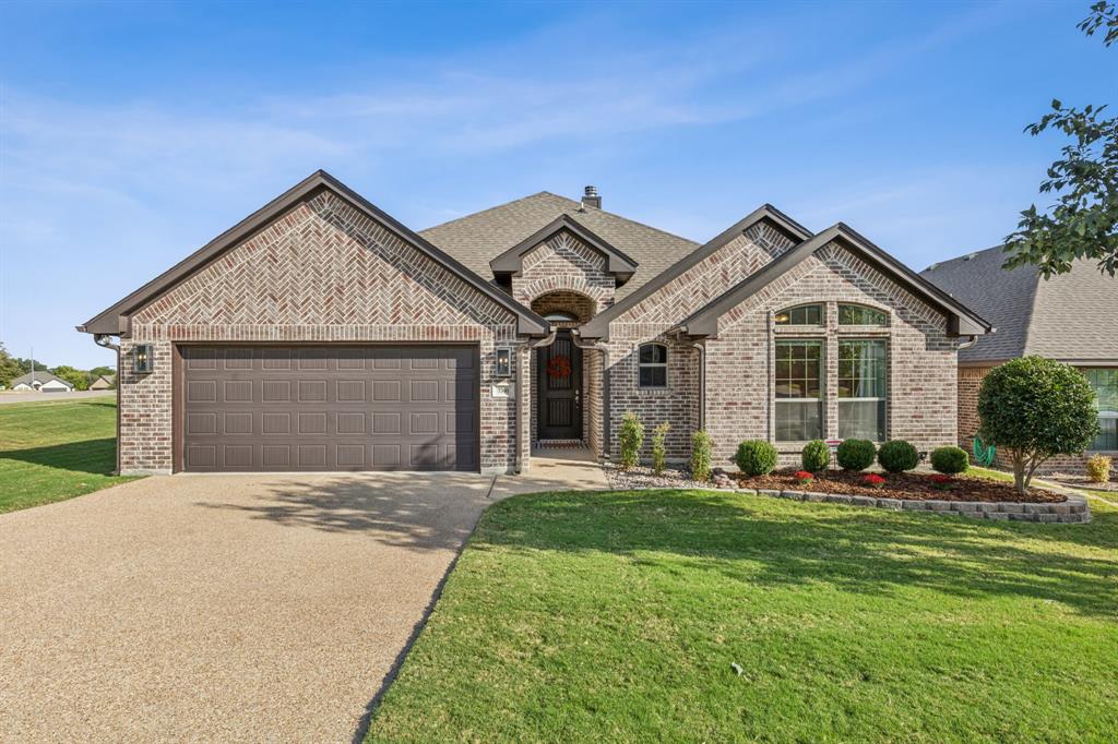 a front view of a house with a yard and garage