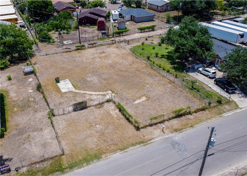 an aerial view of a house with a yard and large tree