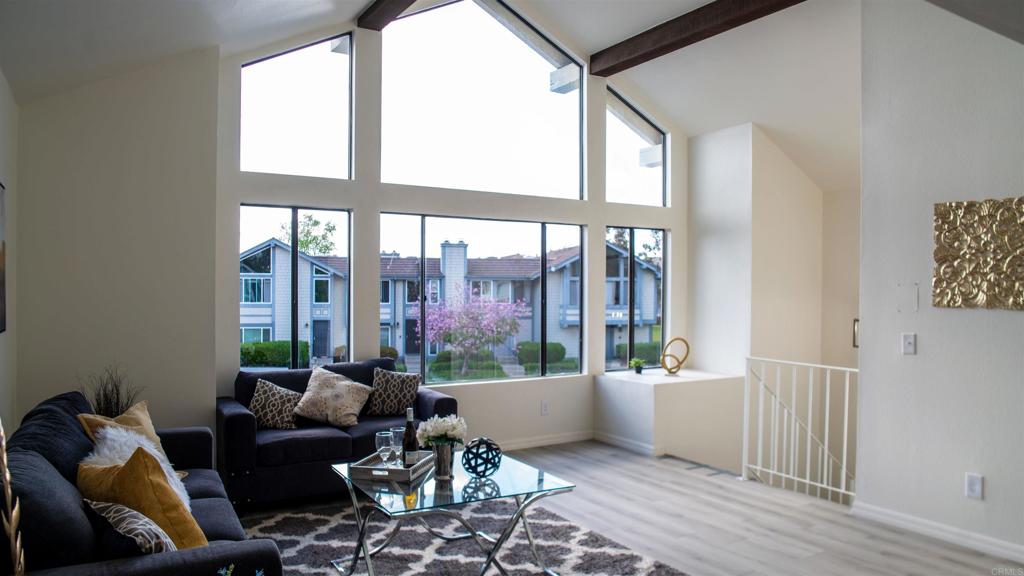 a living room with furniture and a large window