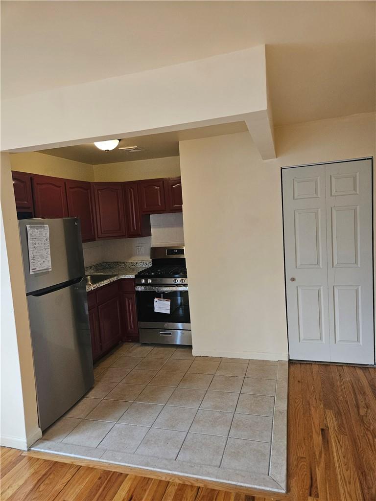 a kitchen with stainless steel appliances a refrigerator and a stove