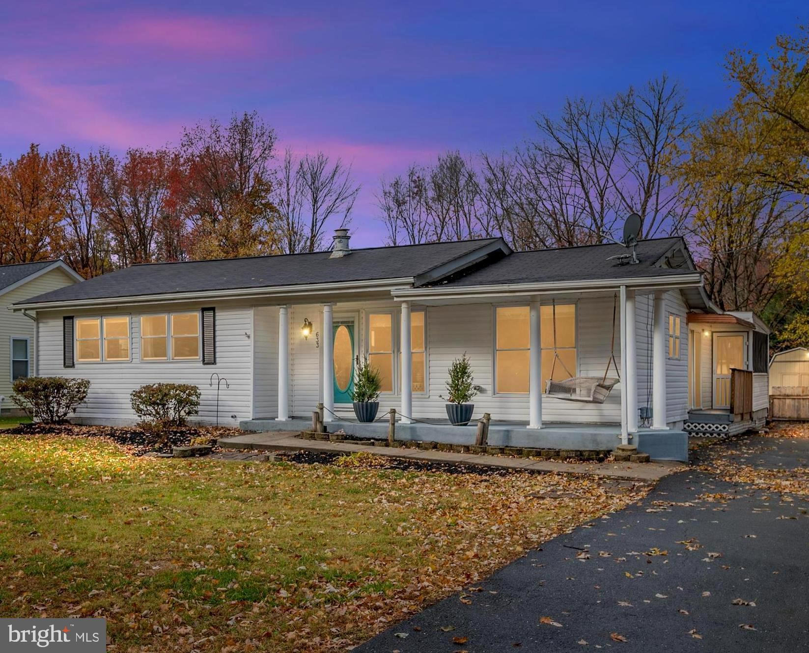 a front view of a house with a yard and seating space