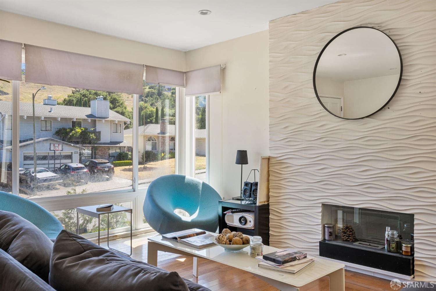 a living room with furniture and a fireplace