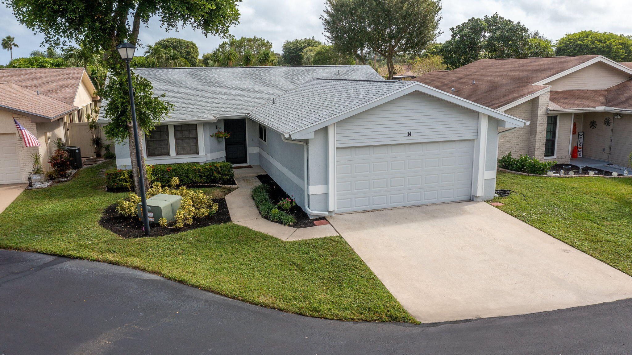 a aerial view of a house with a yard and potted plants