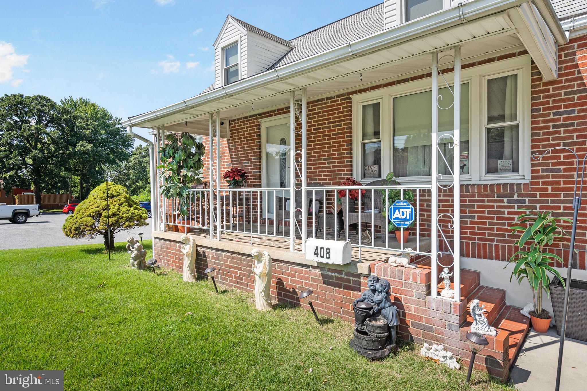 a house view with a sitting space and garden