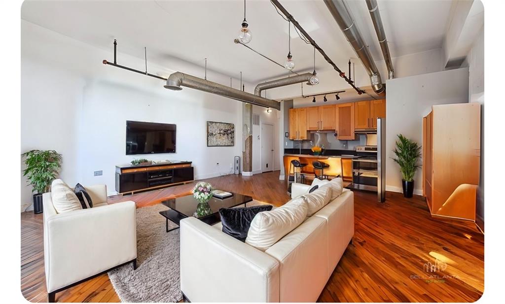 a living room with furniture and a flat screen tv