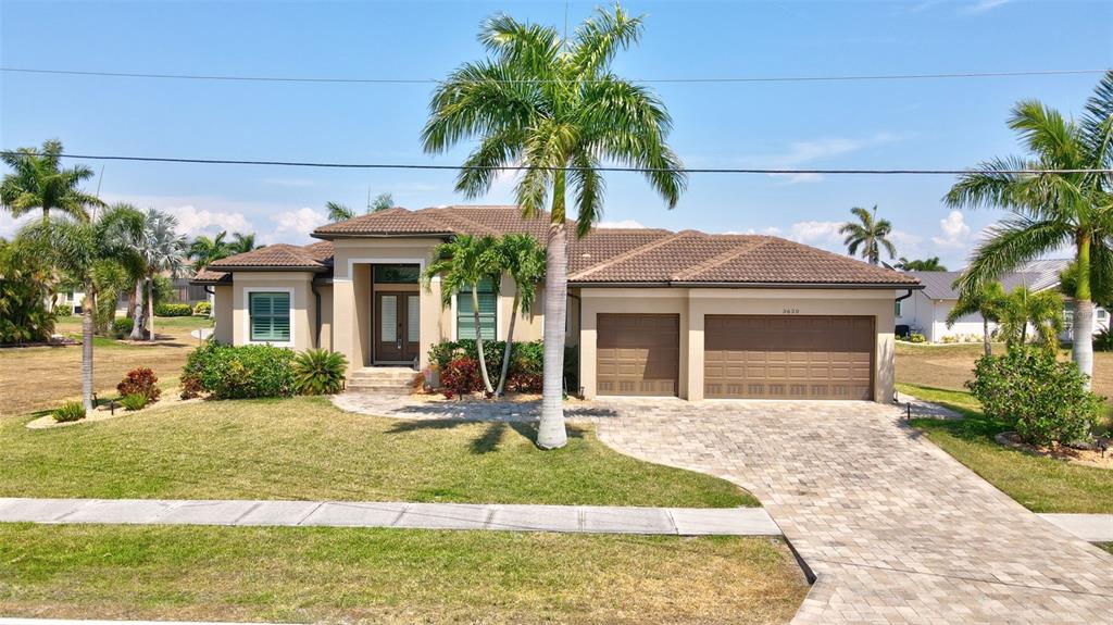 a front view of a house with garden and patio