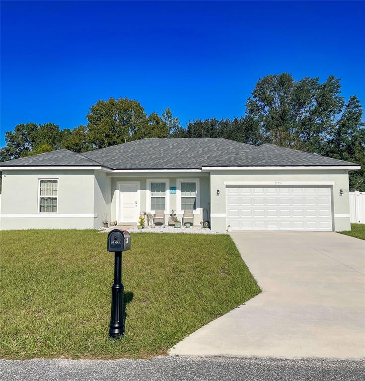 a front view of house with yard and outdoor seating