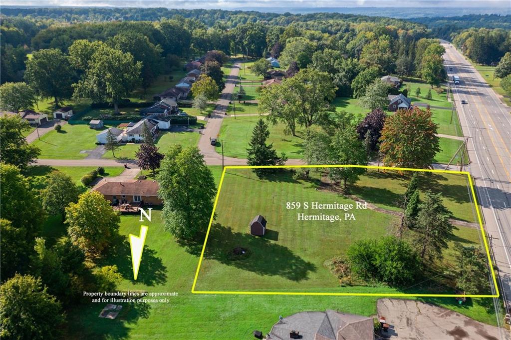 an aerial view of a houses with a yard