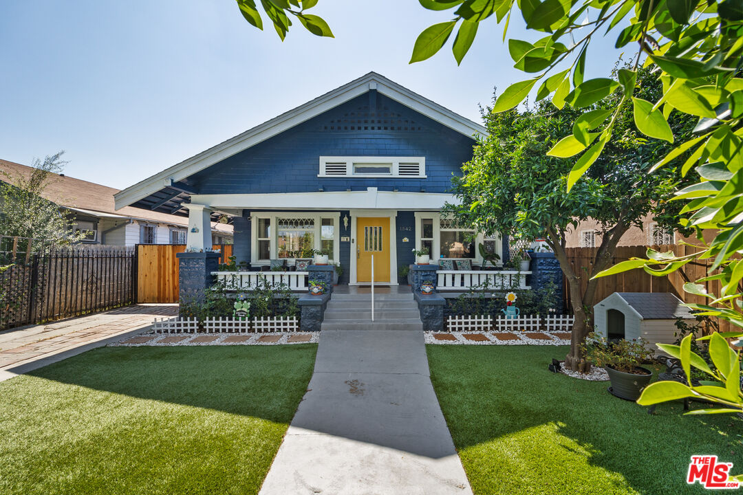 a front view of a house with garden and porch