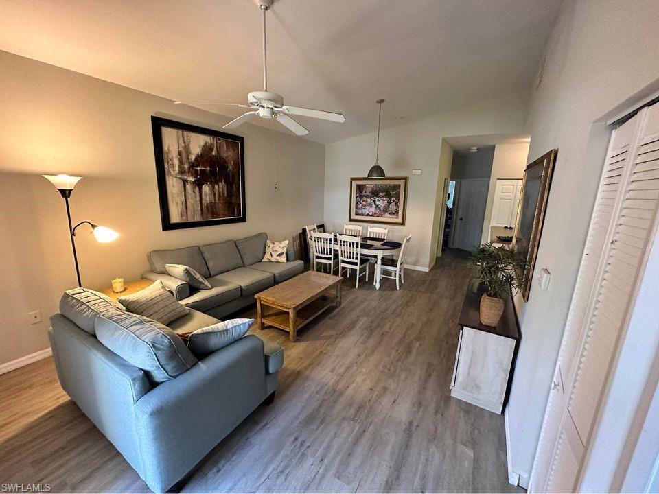 a living room with furniture and a wooden floor