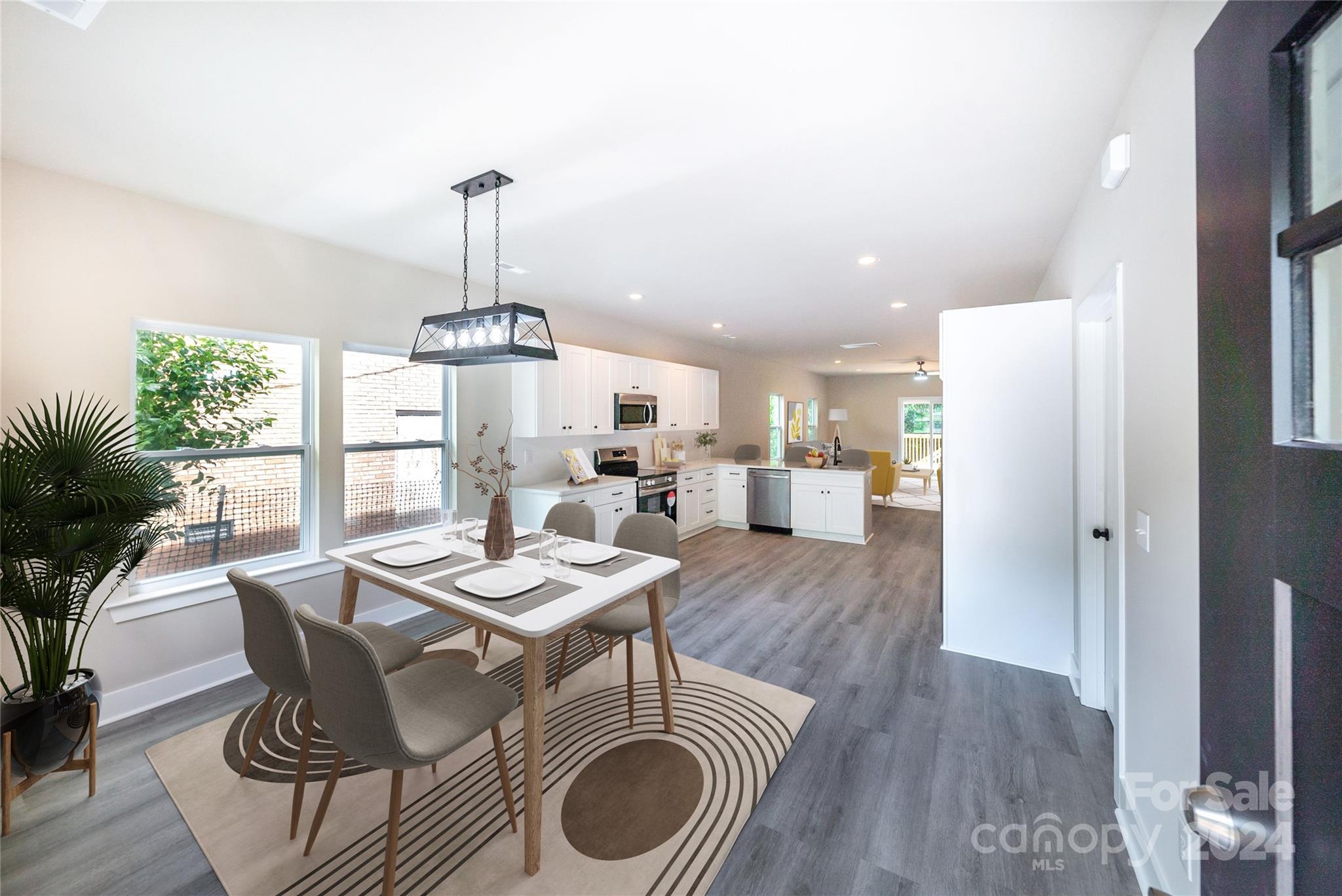 a dining room with furniture a chandelier and wooden floor