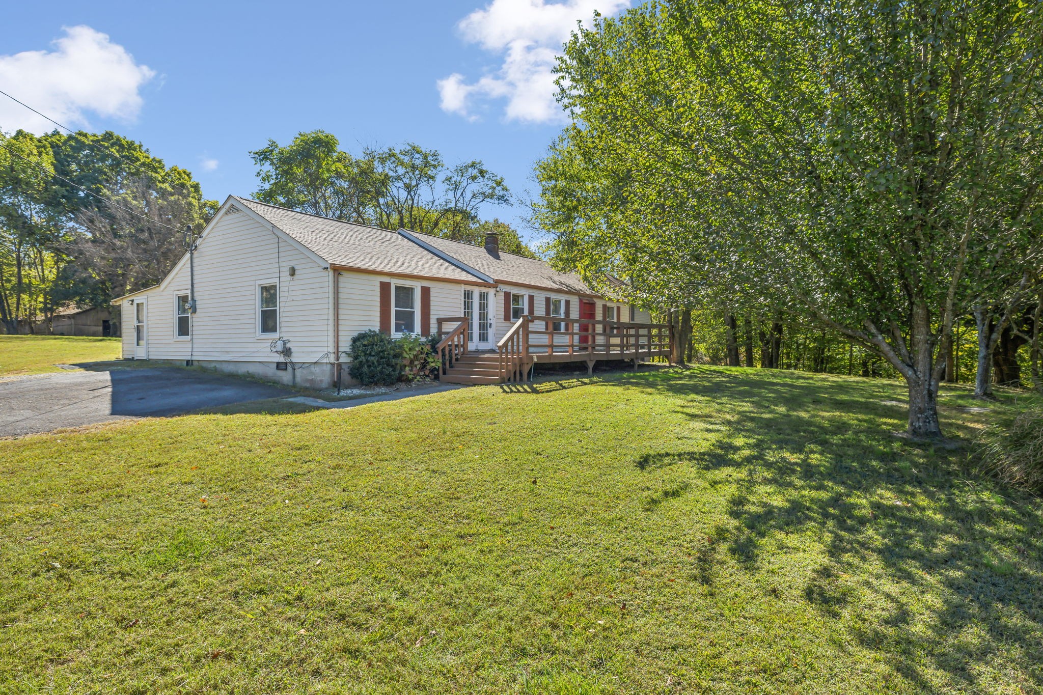 a view of a house with pool and a yard