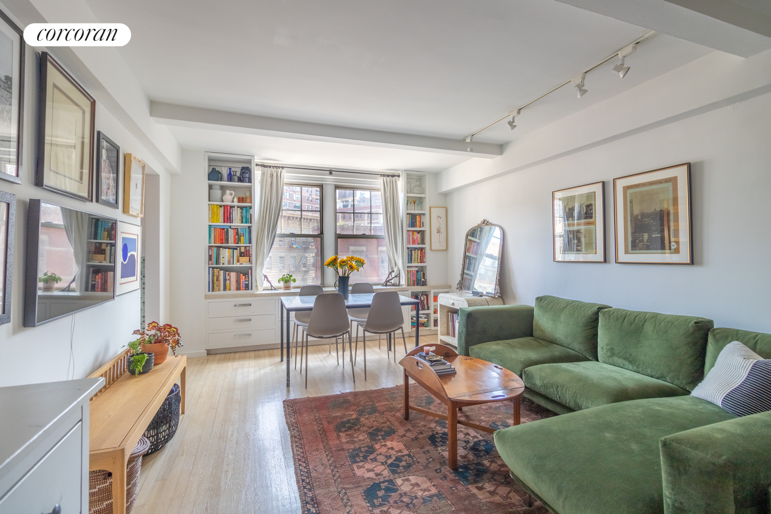 a living room with furniture and wooden floor