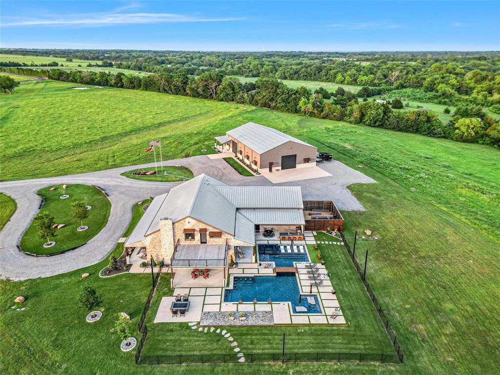 an aerial view of a house with big yard