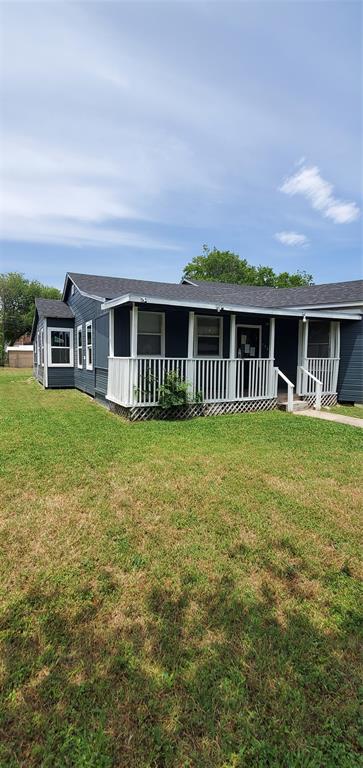 a view of a house with a yard and sitting area