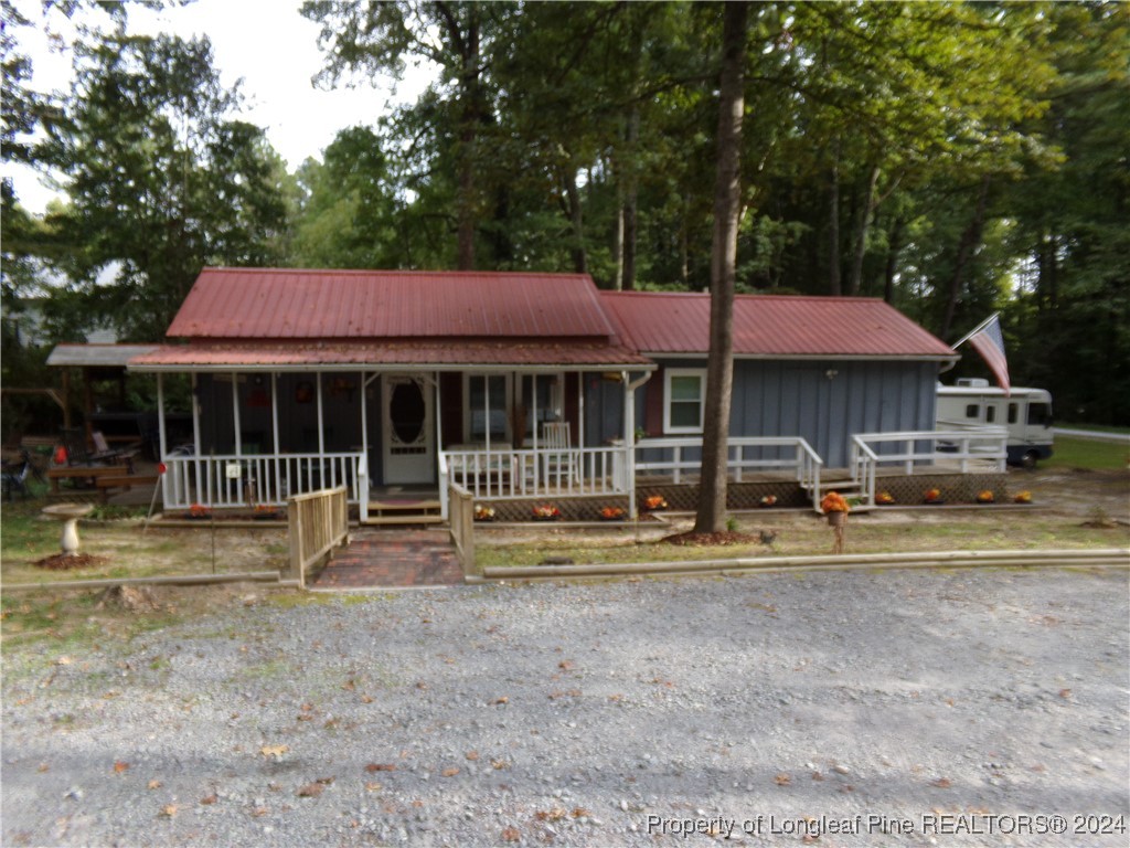 a front view of a house with a yard table and chairs