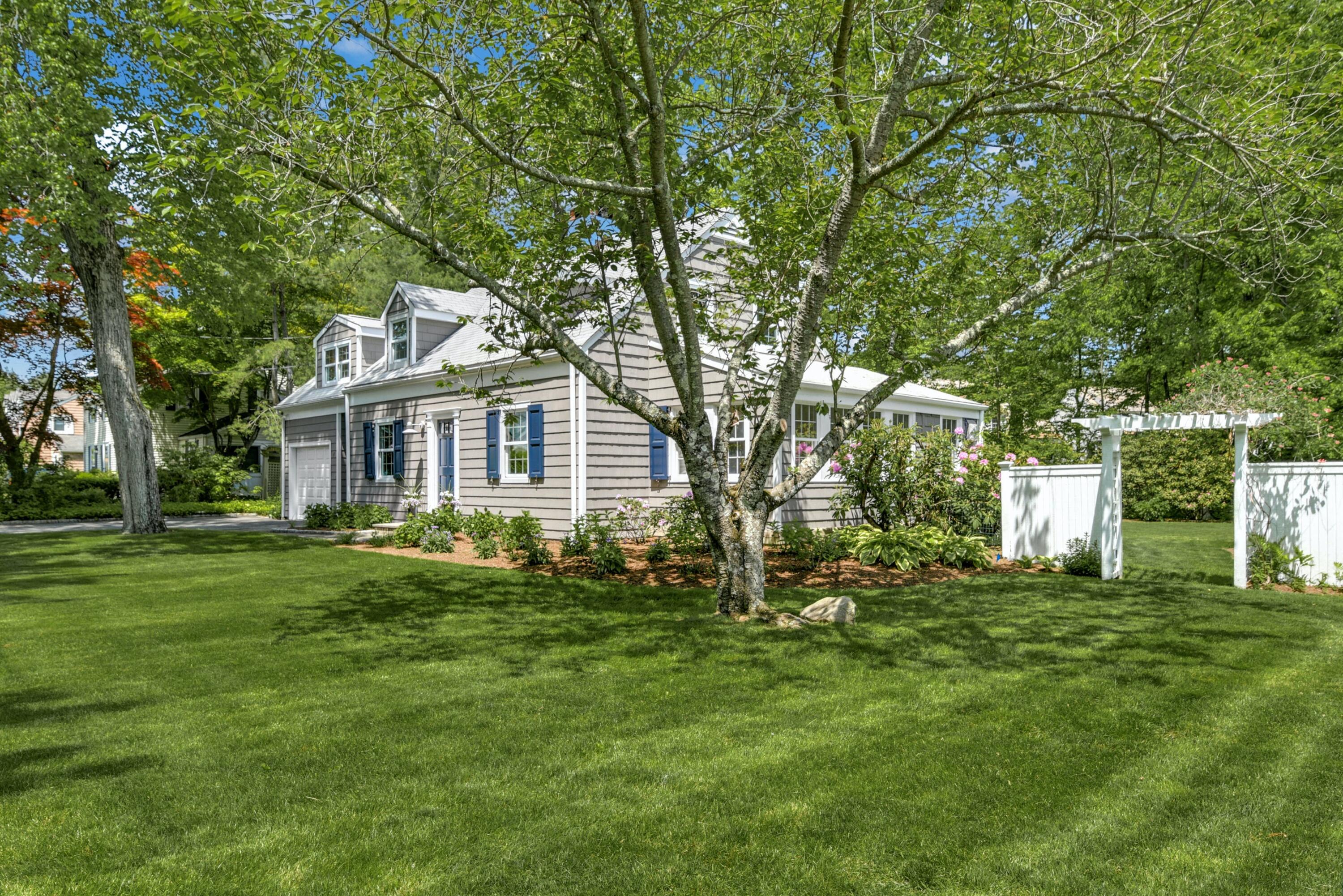 a front view of a house with a garden