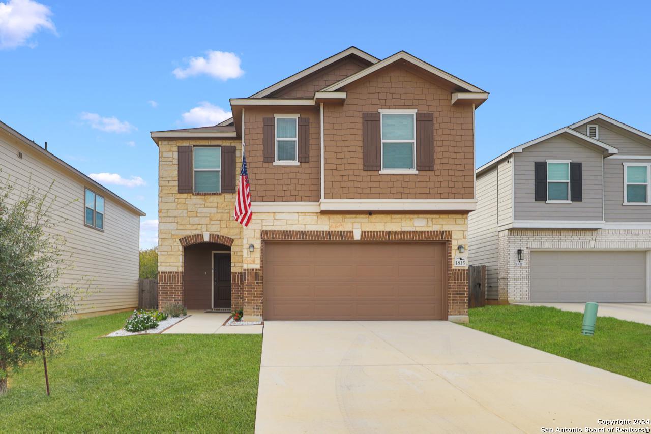 a front view of a house with a yard and garage