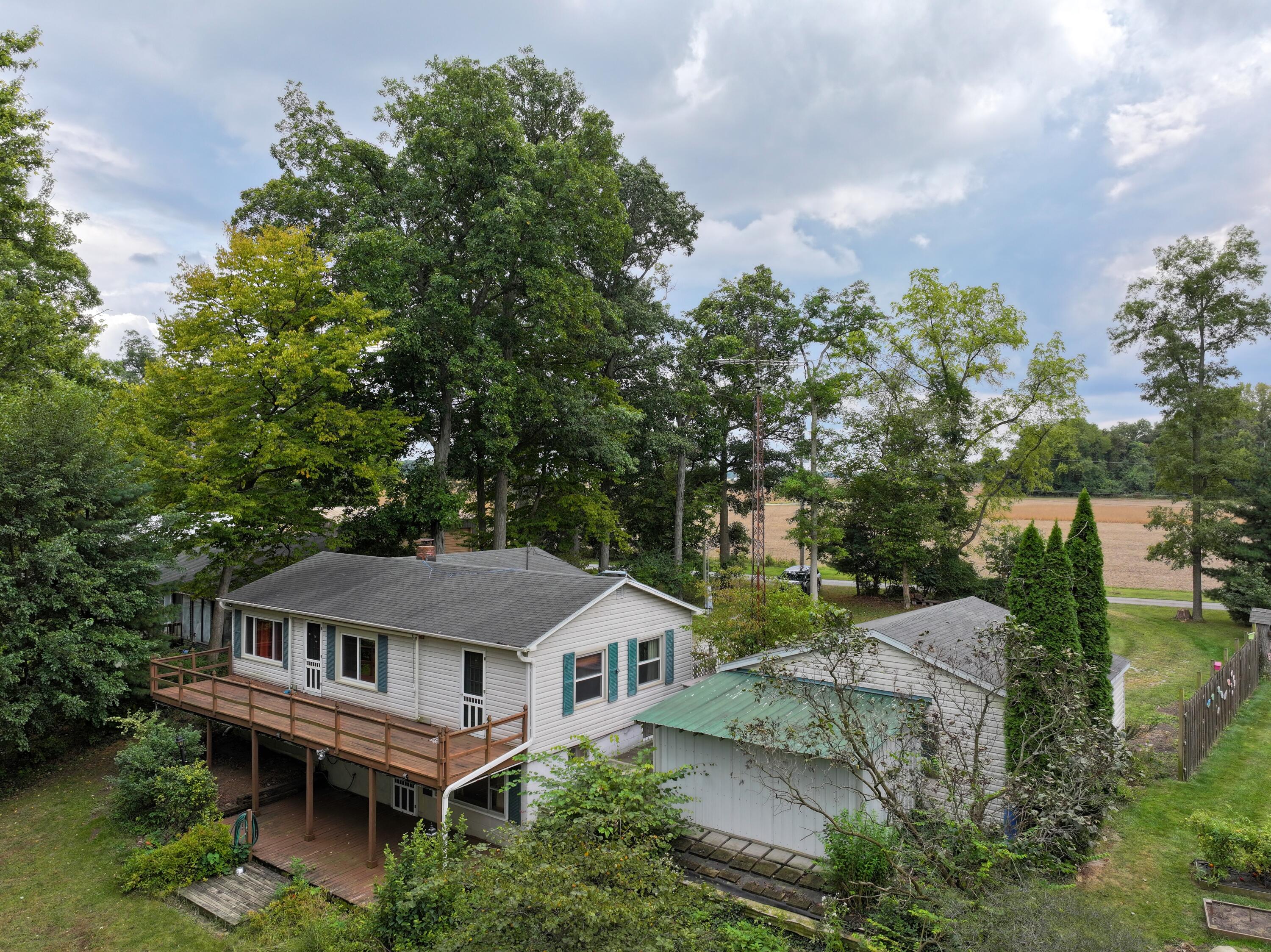 a aerial view of a house with a yard and potted plants