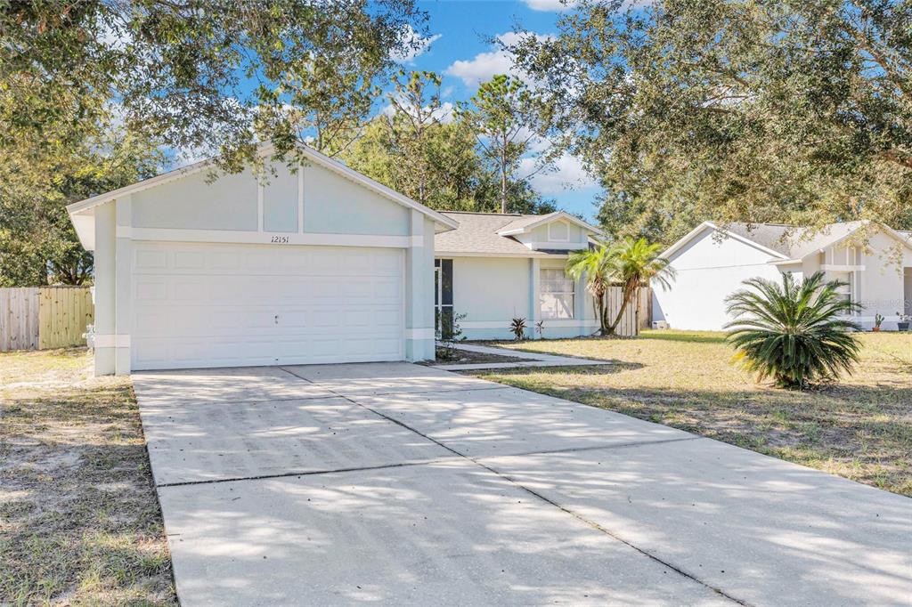 a view of a house with a yard and garage